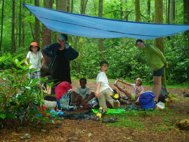 kids under tarp in camp