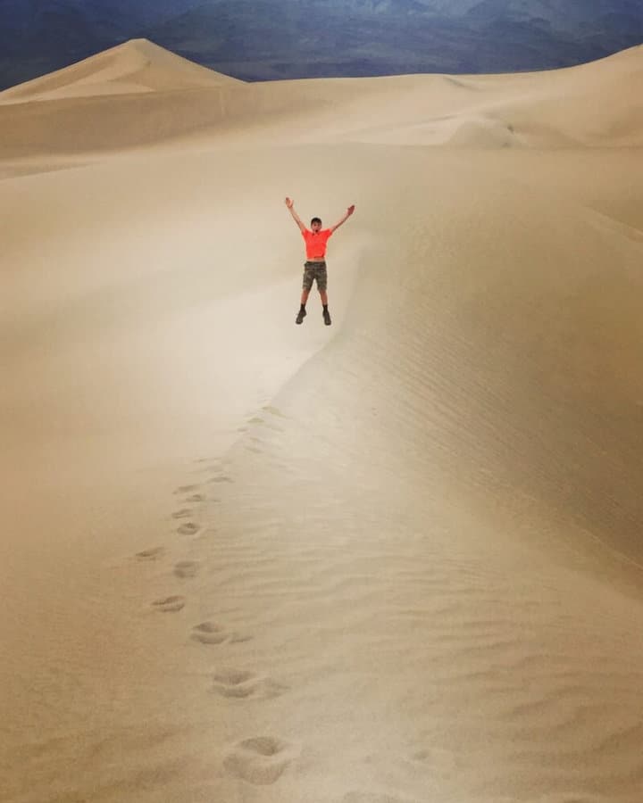 Aidan jumping on dunes