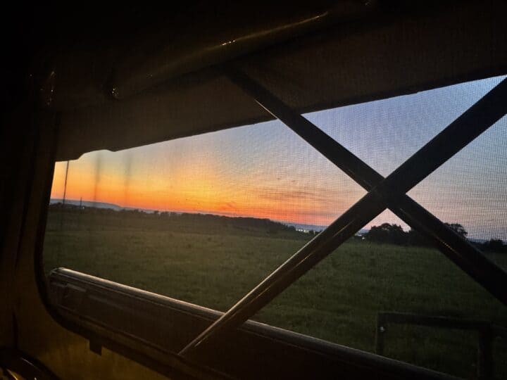 A view of the sunrise from inside a vehicle.