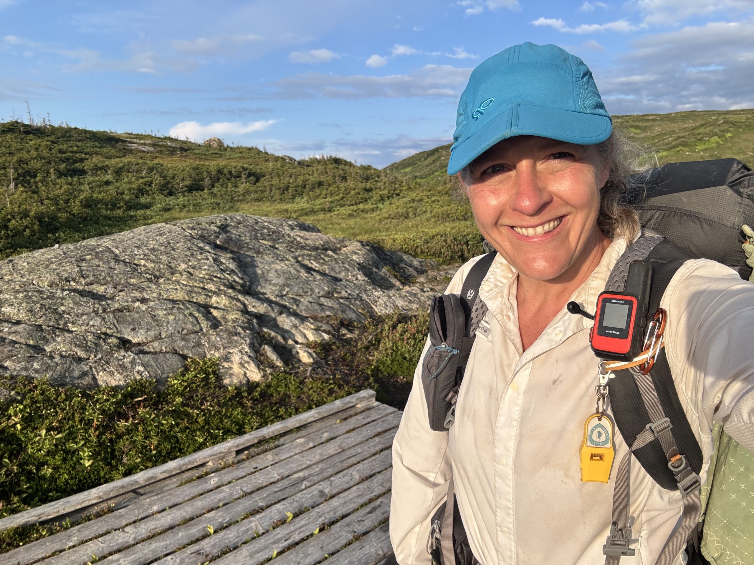 woman in front of a rock