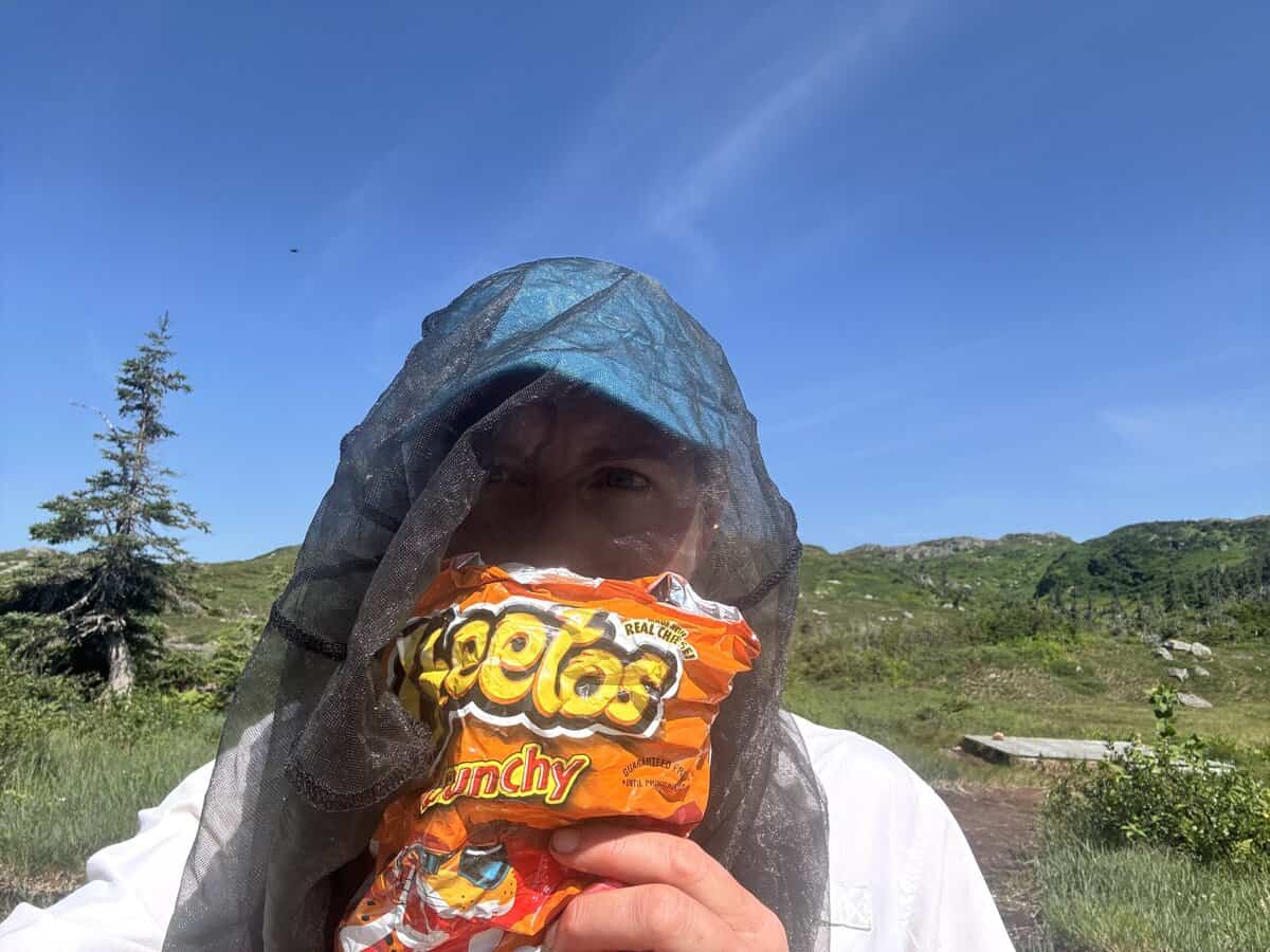 woman with head net and Cheetos