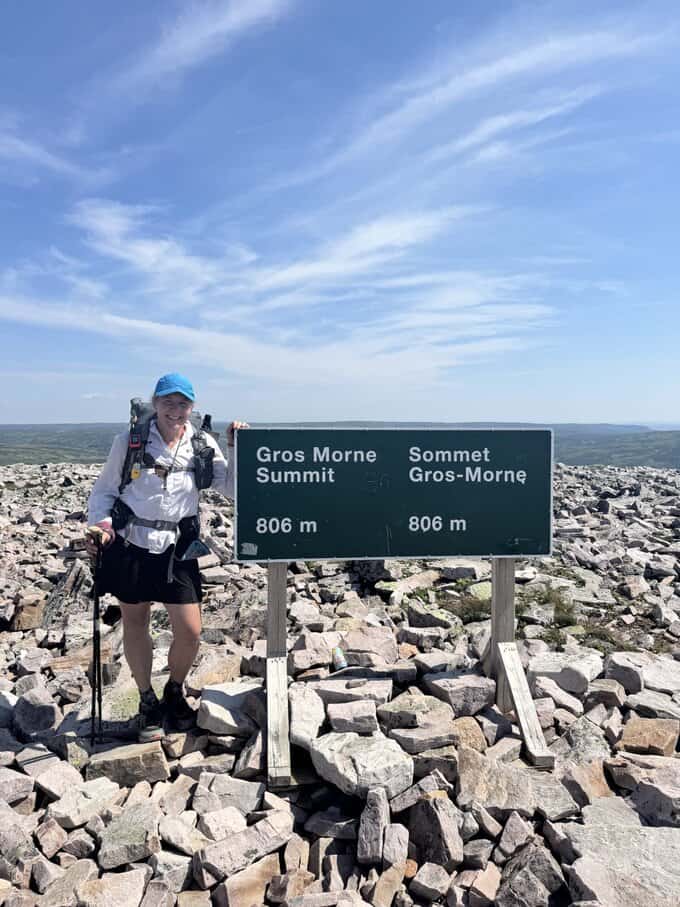 woman on rocky summit of Gros Morne.